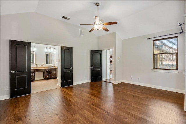 11609 Woodland Hills Trl, Austin, TX 78732 - unfurnished bedroom featuring dark wood-type flooring, baseboards, a sink, high vaulted ceiling, and a ceiling fan