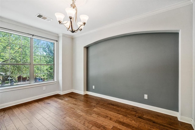 11609 Woodland Hills Trl, Austin, TX 78732 - spare room featuring dark wood-type flooring, baseboards, a chandelier, crown molding, and arched walkways
