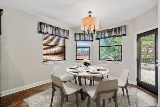 11609 Woodland Hills Trl, Austin, TX 78732 - tiled dining space with healthy amount of natural light, a chandelier, and baseboards