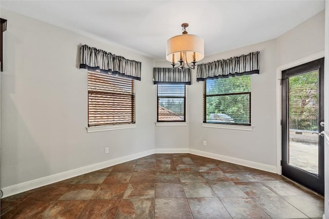 11609 Woodland Hills Trl, Austin, TX 78732 - unfurnished dining area with plenty of natural light, baseboards, stone finish flooring, and a chandelier