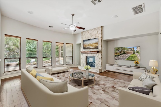 11609 Woodland Hills Trl, Austin, TX 78732 - living area with a ceiling fan, a stone fireplace, and wood finished floors