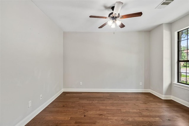 11609 Woodland Hills Trl, Austin, TX 78732 - empty room with plenty of natural light, dark wood-style flooring, and baseboards