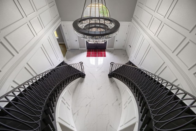4525 Via Roma Pass, Leander, TX 78641 - stairs featuring marble finish flooring, a decorative wall, and wainscoting