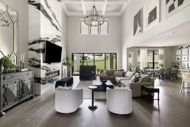 4525 Via Roma Pass, Leander, TX 78641 - living area featuring a chandelier, wood finished floors, coffered ceiling, a high end fireplace, and a towering ceiling