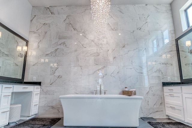 4525 Via Roma Pass, Leander, TX 78641 - bathroom with vanity, a soaking tub, tile walls, and a chandelier