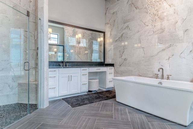 4525 Via Roma Pass, Leander, TX 78641 - full bathroom with tile walls, a soaking tub, vanity, and a shower stall