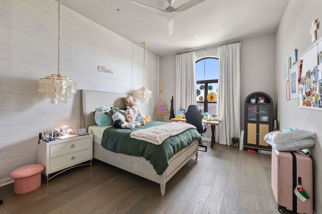 4525 Via Roma Pass, Leander, TX 78641 - bedroom featuring wooden walls, dark wood-type flooring, and ceiling fan