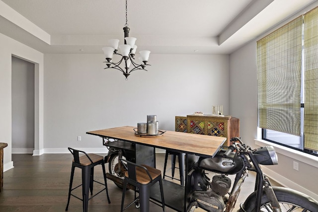 4525 Via Roma Pass, Leander, TX 78641 - dining room with a chandelier, a raised ceiling, dark wood-style flooring, and baseboards