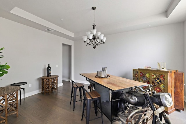 4525 Via Roma Pass, Leander, TX 78641 - dining space with a raised ceiling, a chandelier, wood finished floors, and baseboards