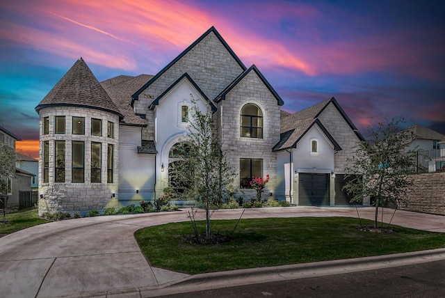 4525 Via Roma Pass, Leander, TX 78641 - french provincial home with stone siding, curved driveway, a lawn, and roof with shingles