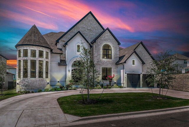4525 Via Roma Pass, Leander, TX 78641 - french provincial home featuring stone siding, curved driveway, a front lawn, and a shingled roof