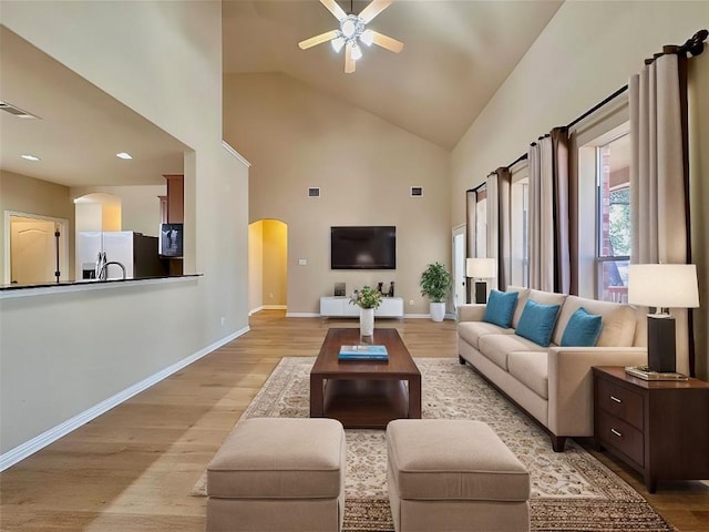 613 Arrowhead Trl, Cedar Park, TX 78613 - living area with arched walkways, ceiling fan, light wood finished floors, high vaulted ceiling, and baseboards