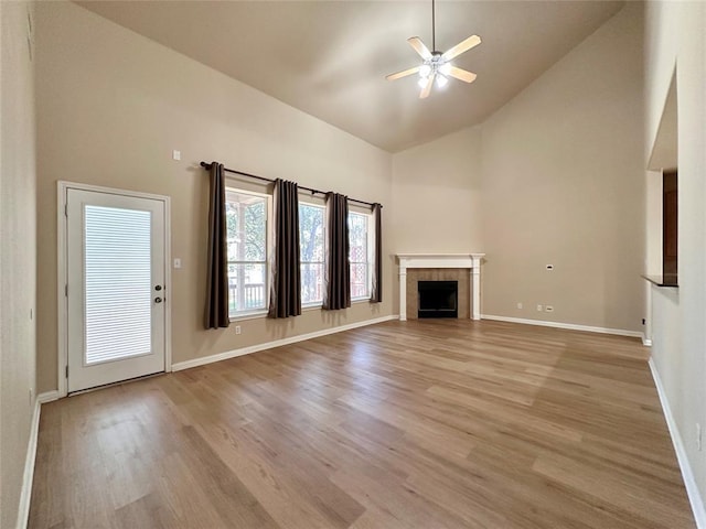 613 Arrowhead Trl, Cedar Park, TX 78613 - unfurnished living room featuring high vaulted ceiling, light wood-style floors, ceiling fan, a fireplace, and baseboards