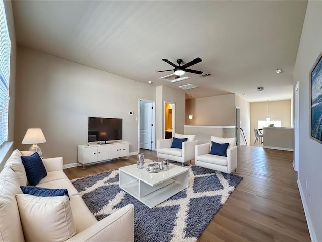 613 Arrowhead Trl, Cedar Park, TX 78613 - living room with wood finished floors, baseboards, and ceiling fan