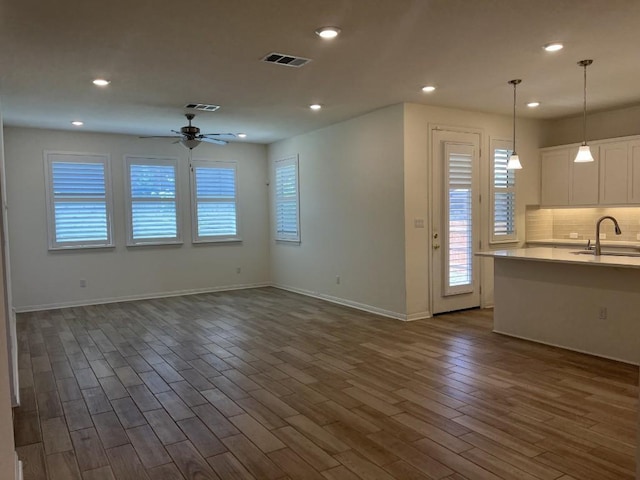 19316 Fernando Trl, Austin, TX 78738 - unfurnished living room with visible vents, a sink, dark wood-style flooring, a ceiling fan, and recessed lighting