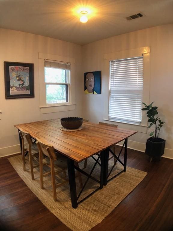 900 W Lynn St, Austin, TX 78703 - dining area featuring baseboards and dark wood-type flooring