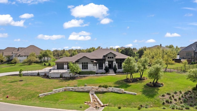view of front facade featuring a front yard, stone siding, and fence