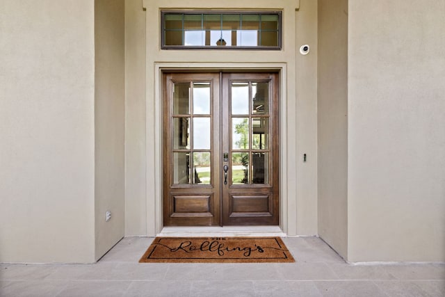 doorway to property with french doors and stucco siding