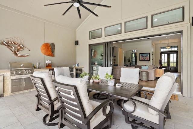 view of patio featuring outdoor dining space, grilling area, area for grilling, ceiling fan, and a sink