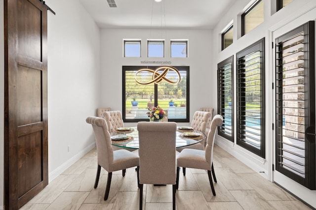 dining room with baseboards, marble finish floor, and a high ceiling