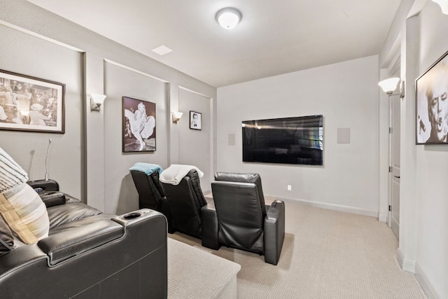 home theater room featuring light carpet and baseboards