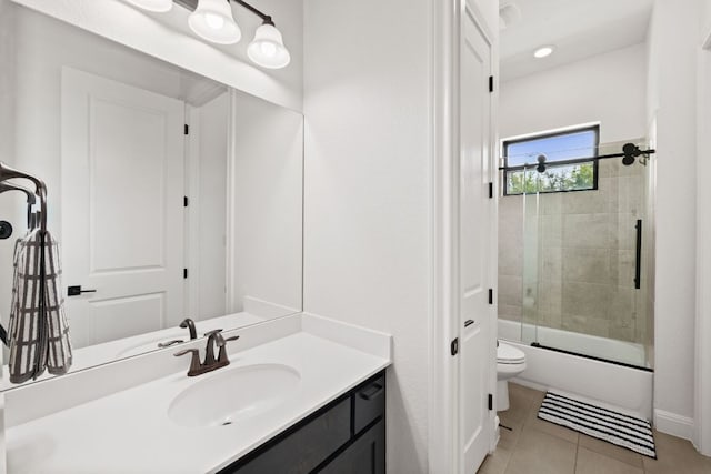 full bathroom with tile patterned flooring, vanity, toilet, and bath / shower combo with glass door