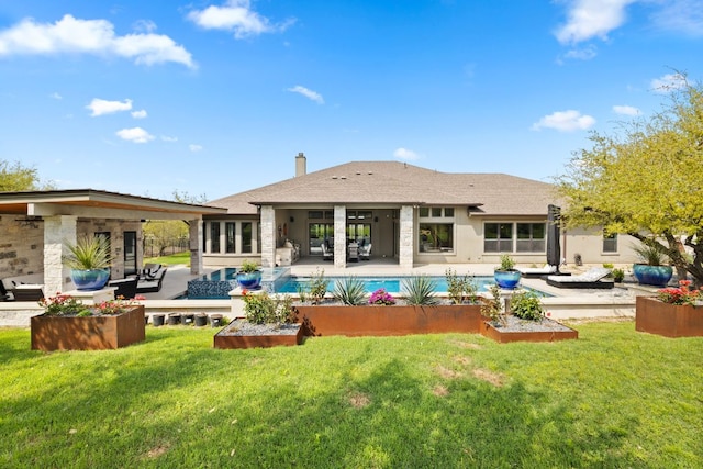 back of property with a patio area, an outdoor living space, and a lawn