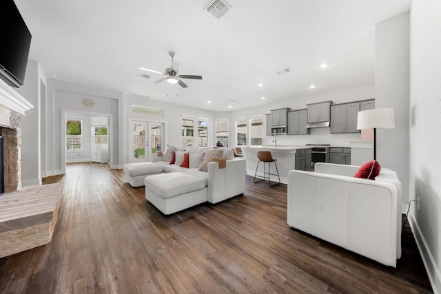 134 Soft Elm Dr, Buda, TX 78610 - living area featuring a fireplace, dark wood finished floors, ceiling fan, baseboards, and recessed lighting