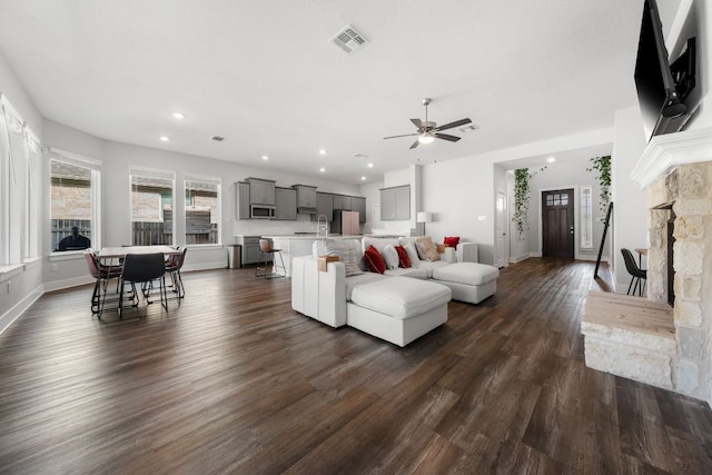 134 Soft Elm Dr, Buda, TX 78610 - living room featuring ceiling fan, dark wood finished floors, baseboards, recessed lighting, and a fireplace