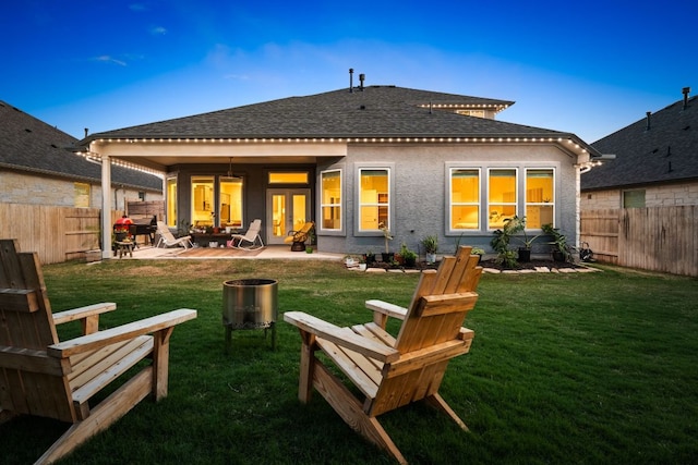 134 Soft Elm Dr, Buda, TX 78610 - back of property featuring a patio area and a shingled roof