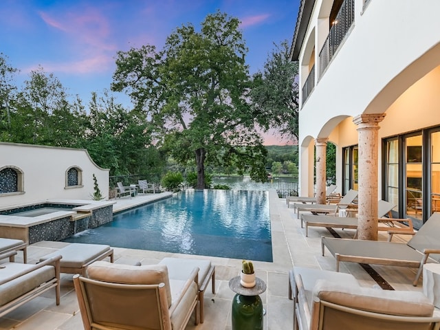 1614 Bruton Springs Rd, Austin, TX 78733 - view of swimming pool featuring a pool with connected hot tub, a patio, and an outdoor hangout area