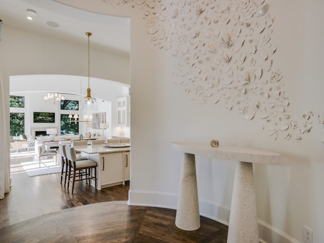 1614 Bruton Springs Rd, Austin, TX 78733 - bar area featuring dark wood-type flooring, hanging light fixtures, baseboards, a chandelier, and lofted ceiling
