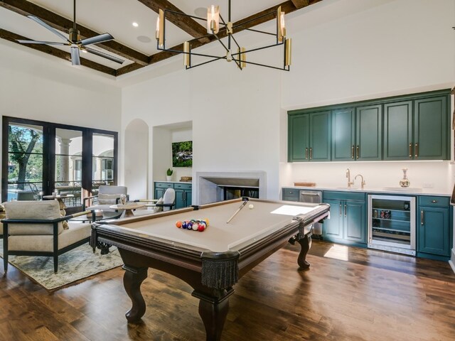 1614 Bruton Springs Rd, Austin, TX 78733 - recreation room with wine cooler, a high ceiling, wet bar, beam ceiling, and a fireplace