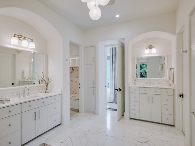 1614 Bruton Springs Rd, Austin, TX 78733 - bathroom featuring two vanities, marble look tiles, and recessed lighting