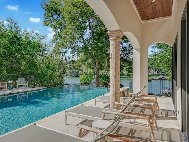 1614 Bruton Springs Rd, Austin, TX 78733 - view of pool featuring an infinity pool, a water view, and a patio