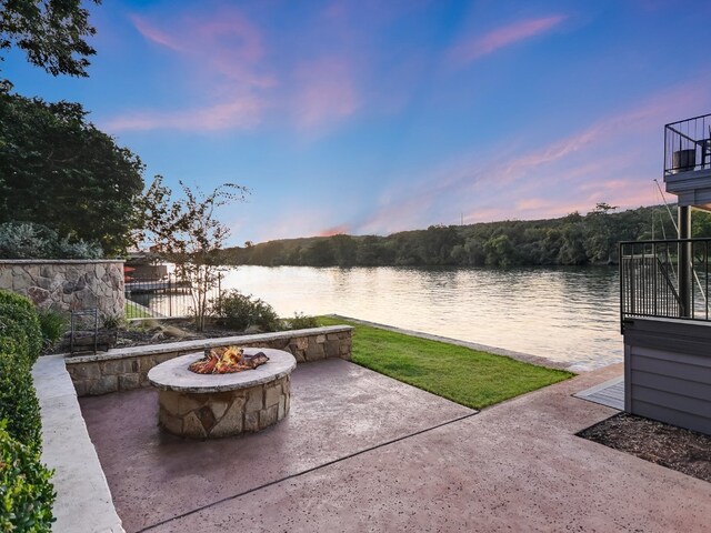1614 Bruton Springs Rd, Austin, TX 78733 - patio terrace at dusk with a fire pit, a patio area, and a water view