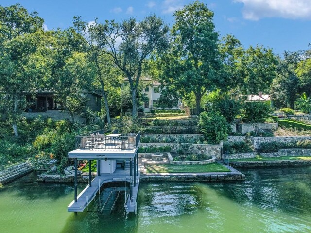 1614 Bruton Springs Rd, Austin, TX 78733 - dock featuring a water view, boat lift, and view of wooded area