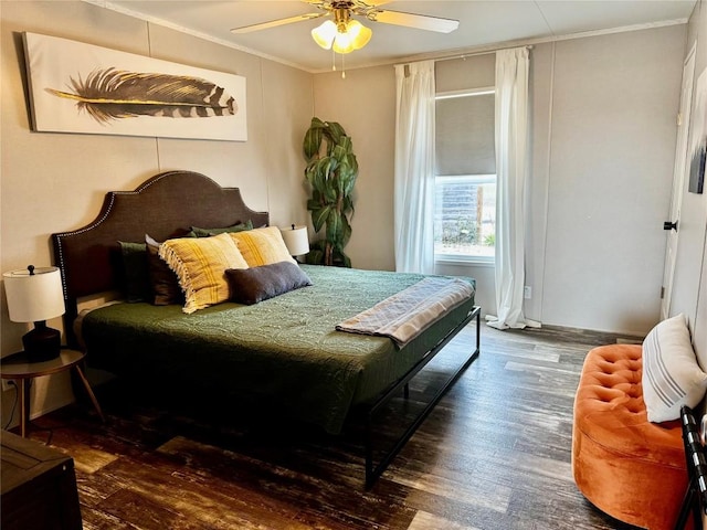 bedroom with wood finished floors, crown molding, and a ceiling fan