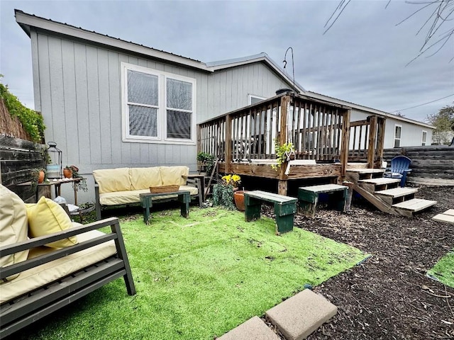 back of house with outdoor lounge area, fence, and a deck