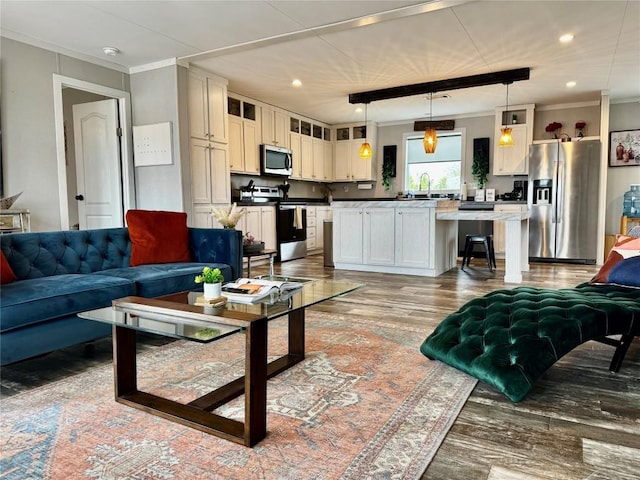 living room with wood finished floors, recessed lighting, and crown molding