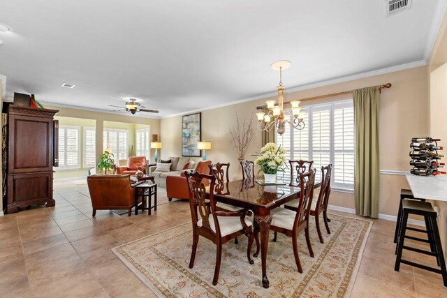 108 Silver Bonnet Dr, Georgetown, TX 78633 - dining room featuring crown molding, a chandelier, light tile patterned flooring, and a ceiling fan