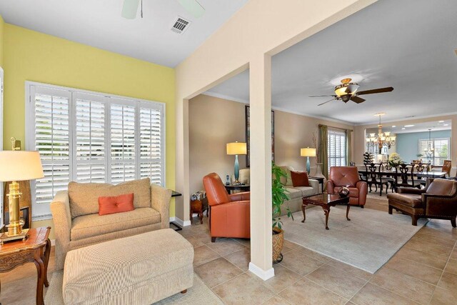 108 Silver Bonnet Dr, Georgetown, TX 78633 - living area featuring ceiling fan, a chandelier, light tile patterned flooring, and ornamental molding