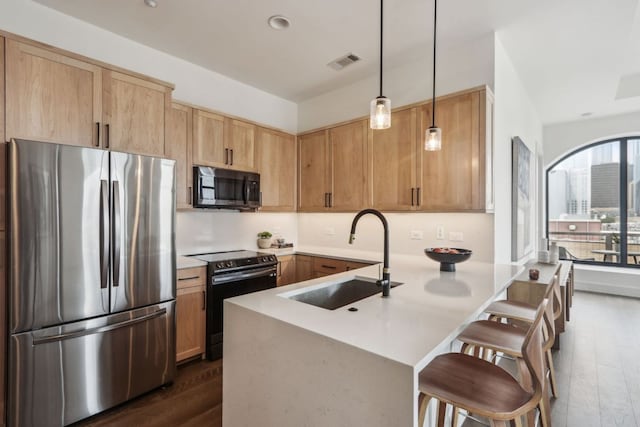 507 Sabine St Unit 601, Austin, TX 78701 - kitchen featuring freestanding refrigerator, black range with electric stovetop, a sink, dark wood-style flooring, and a peninsula