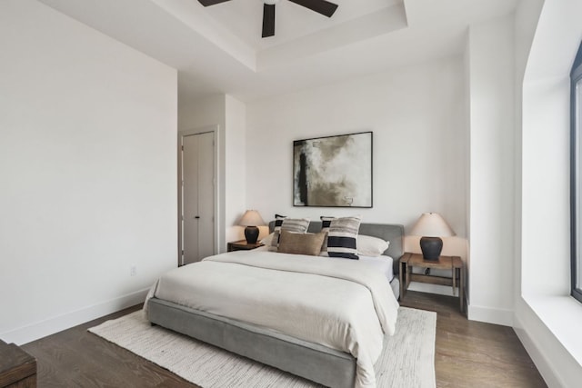 507 Sabine St Unit 601, Austin, TX 78701 - bedroom with baseboards, wood finished floors, a raised ceiling, and ceiling fan