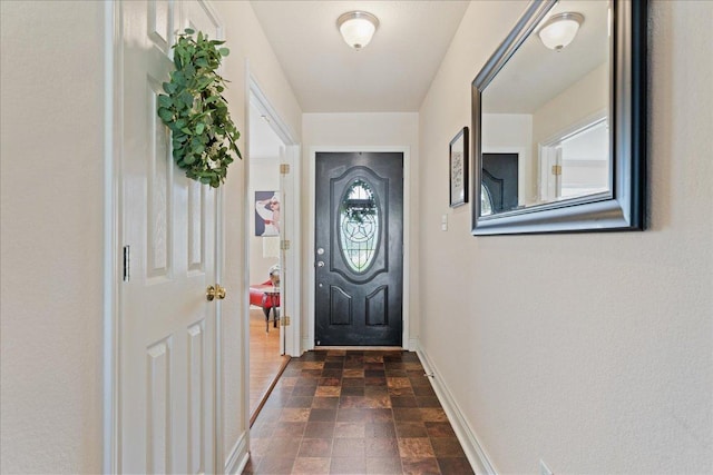 125 Fairway Ct, Bastrop, TX 78602 - doorway with baseboards and stone finish floors
