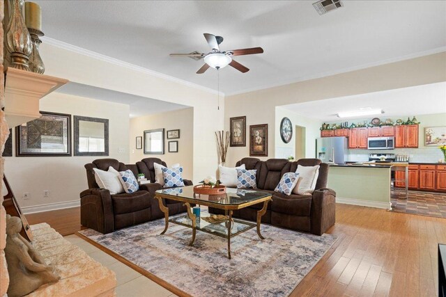 125 Fairway Ct, Bastrop, TX 78602 - living area featuring a ceiling fan, light wood-style floors, and crown molding