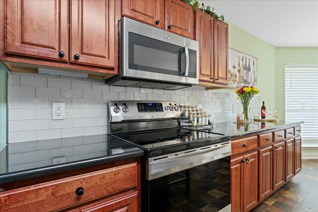 125 Fairway Ct, Bastrop, TX 78602 - kitchen with stainless steel appliances, brown cabinetry, decorative backsplash, and dark countertops
