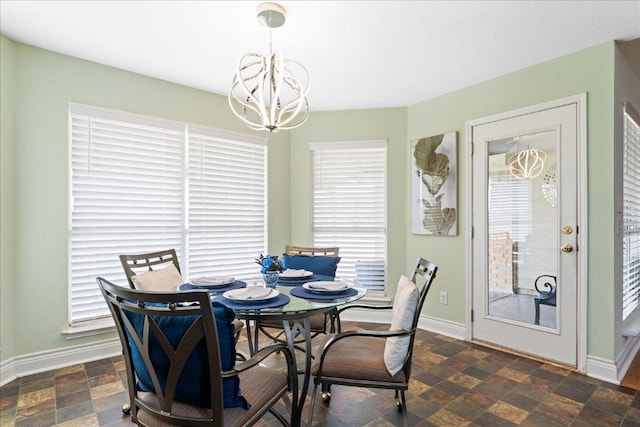 125 Fairway Ct, Bastrop, TX 78602 - dining area with a chandelier, healthy amount of natural light, and stone finish flooring