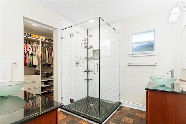 125 Fairway Ct, Bastrop, TX 78602 - full bathroom featuring vanity, a stall shower, and a spacious closet