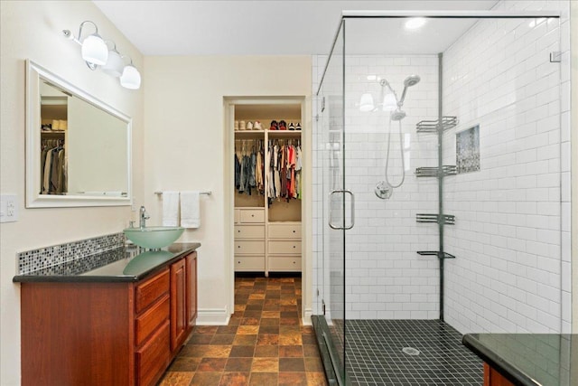 125 Fairway Ct, Bastrop, TX 78602 - full bathroom with vanity, a spacious closet, and a shower stall